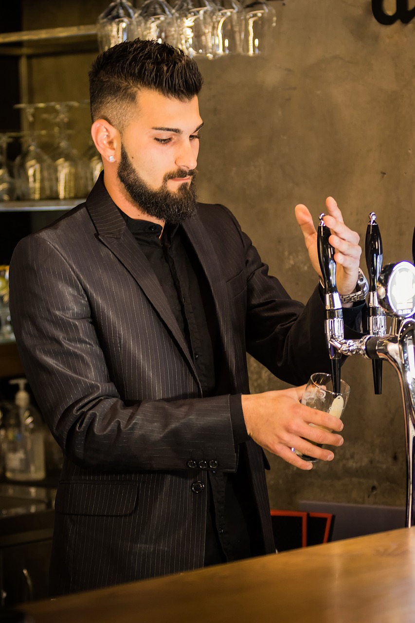 bartender pouring beer at tap