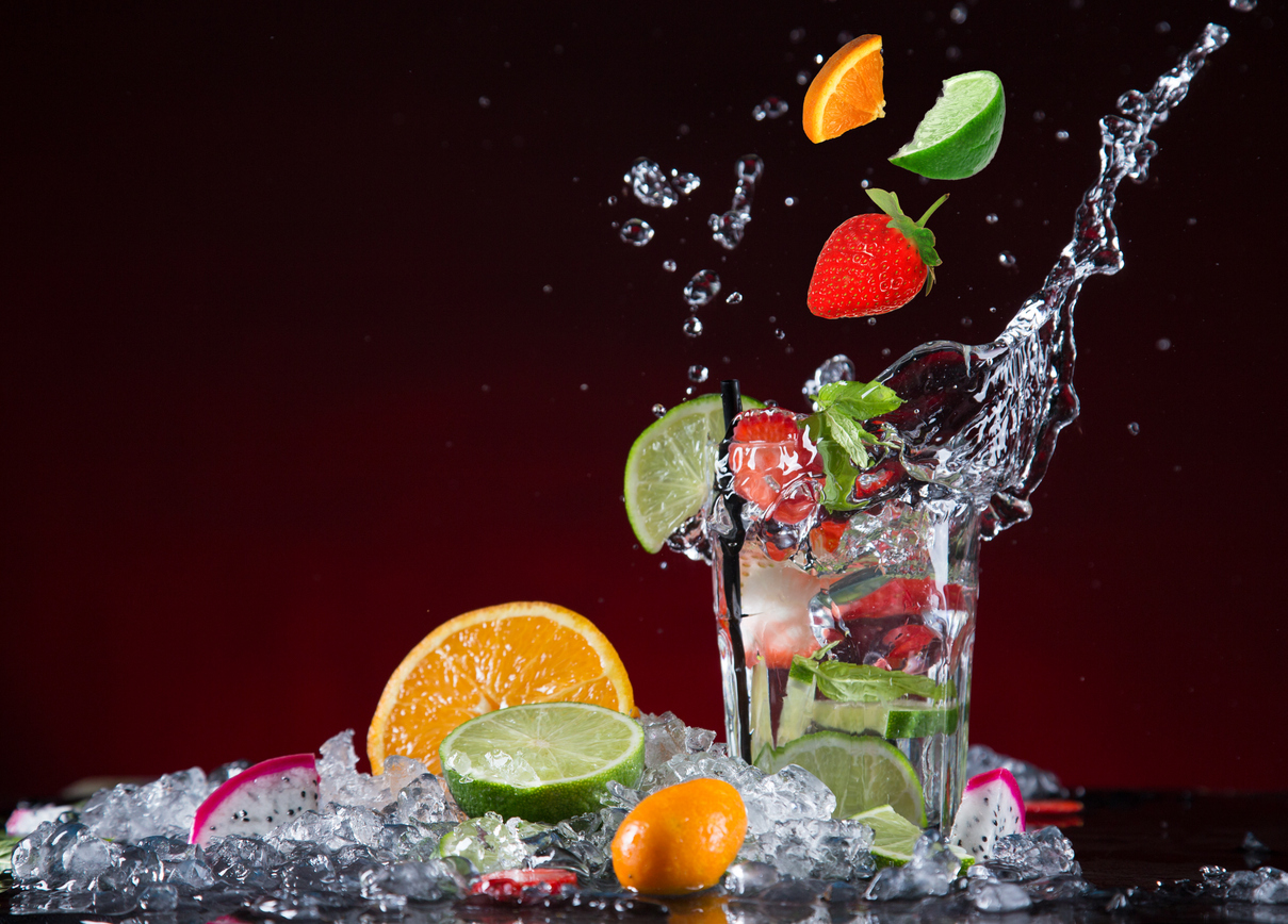 fruit splashes into glass ice orange limes
