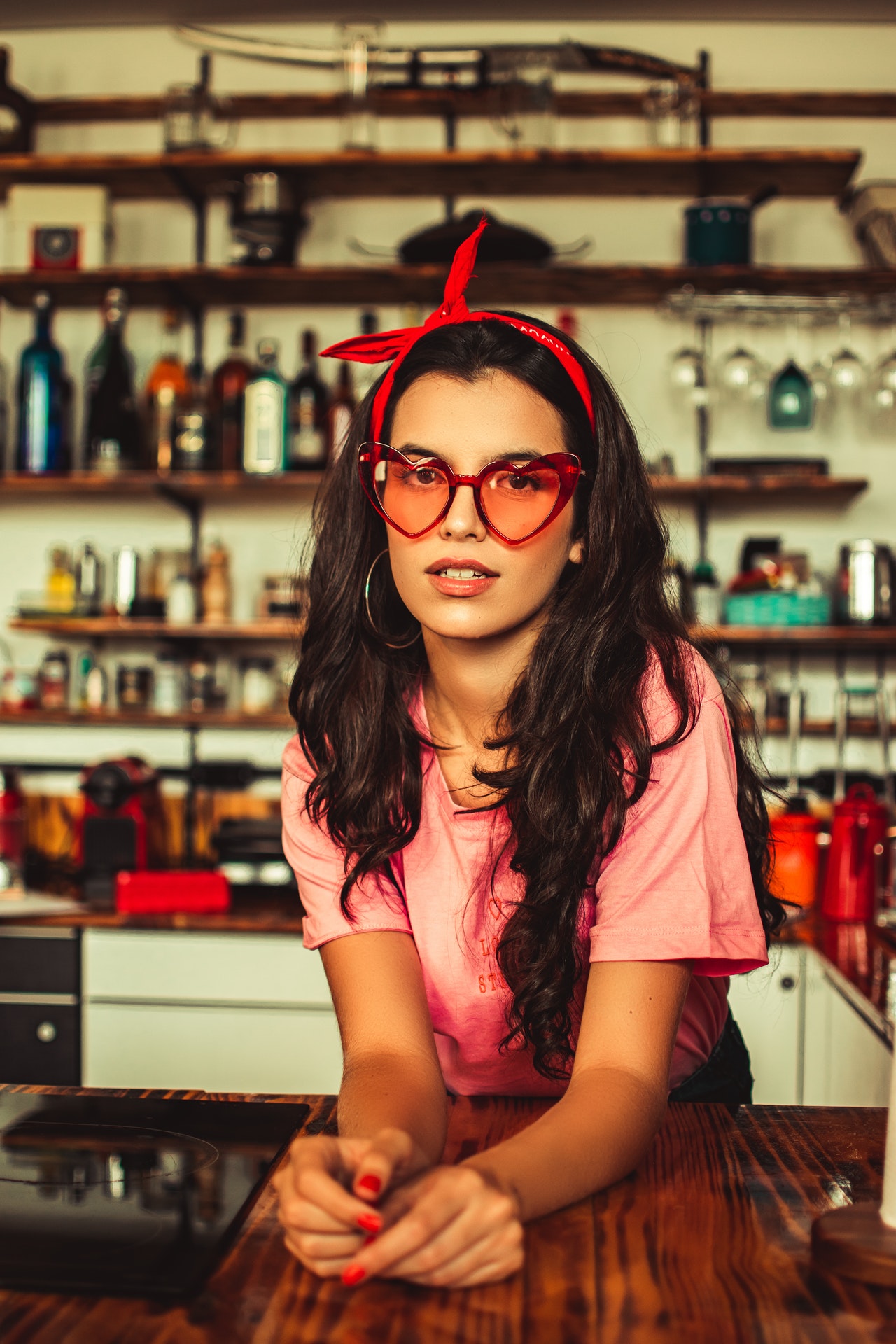 woman wearing red headband and red heartframed sunglasses